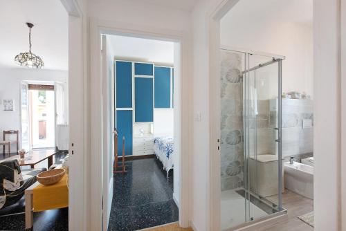 a bathroom with a glass shower and a bedroom at Attico di Silvy e Kikka in Arenzano