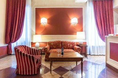 a living room with a couch and a table at Hotel Garda in Milan