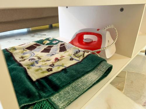 a box with a green towel and a red towel warmer at BayView Suites Port Dickson By MAISON in Port Dickson