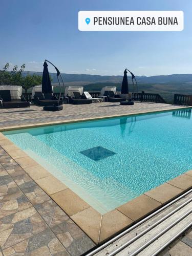 a swimming pool at a villa with a view at Pensiunea Casa Buna in Gîrbova