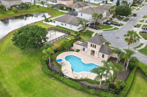 an aerial view of a house with a swimming pool at LONG STAYS! Lakefront - Gated Pool Home in Orlando
