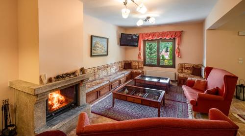 a living room with a fireplace and a tv at Guesthouse Anastasia in Nestórion
