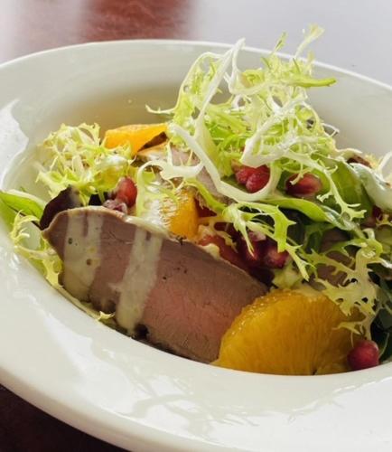 a bowl of food with a salad and meat at The Lilly Restaurant With Rooms in Llandudno