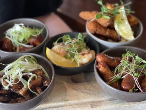 a group of bowls of food on a table at The Lilly Restaurant With Rooms in Llandudno