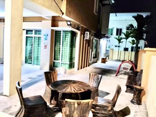 a table and chairs sitting on a patio at JOE Homestay in Alor Setar