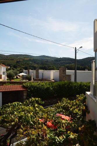 a view from the balcony of a house with plants at Casa do Alfaiate in Chãos