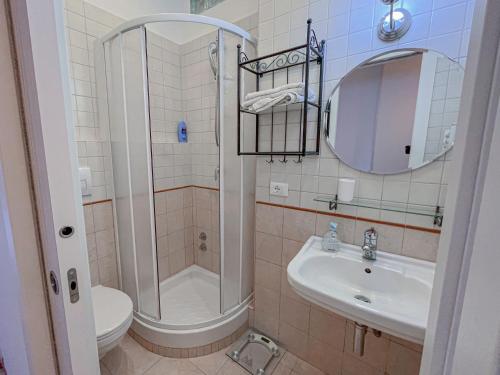 a bathroom with a shower and a sink and a toilet at Aragona Luxury Apartment - Fronte Mare in Taranto