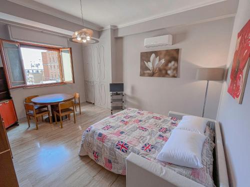 a small bedroom with a bed and a table at Aragona Luxury Apartment - Fronte Mare in Taranto