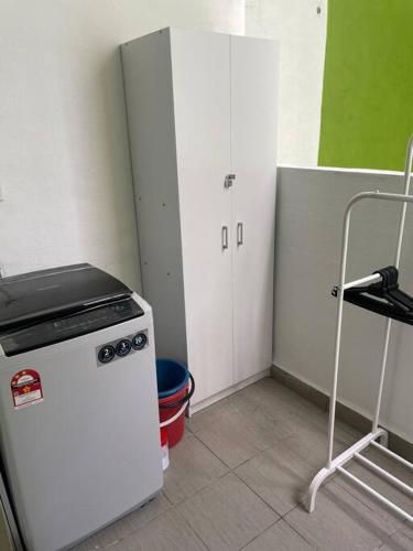 a kitchen with a white refrigerator and a white cabinet at Double AS Homestay in Putrajaya