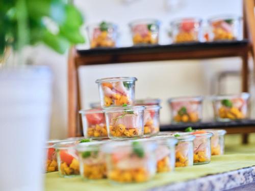 a group of plastic containers filled with fruit on a table at Hotel Planai by Alpeffect Hotels in Schladming