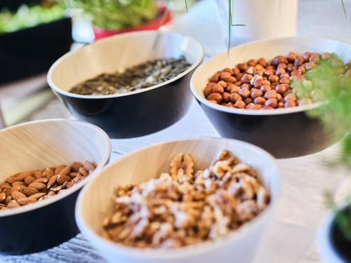a table topped with bowls of different types of nuts at Hotel Planai by Alpeffect Hotels in Schladming