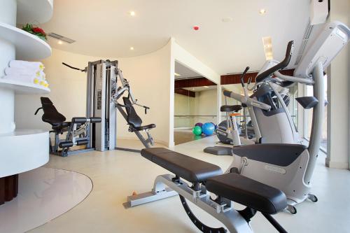 a gym with several tread machines in a room at Mercure Bali Nusa Dua in Nusa Dua