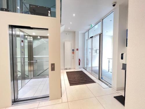 einen leeren Flur mit Glastüren in einem Gebäude in der Unterkunft ART HOTEL HOUSE ONE in Baden-Baden