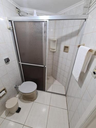 a bathroom with a shower and a toilet in it at Village I in Peruíbe