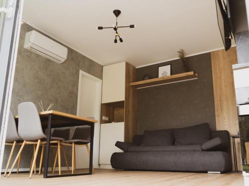 a living room with a couch and a table at Mobilna hiška pod Lipo in Velenje