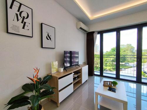 a living room with a tv and a large window at ONE Homestay B 6Pax 2Rooms in Sibu