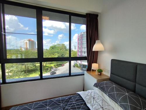 a bedroom with a bed and a large window at ONE Homestay B 6Pax 2Rooms in Sibu