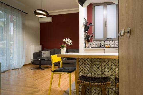 a kitchen and living room with a table and yellow chairs at Athens Special in Athens
