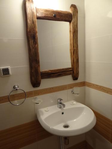 a bathroom with a sink and a mirror on the wall at Недкова къща in Koprivshtitsa
