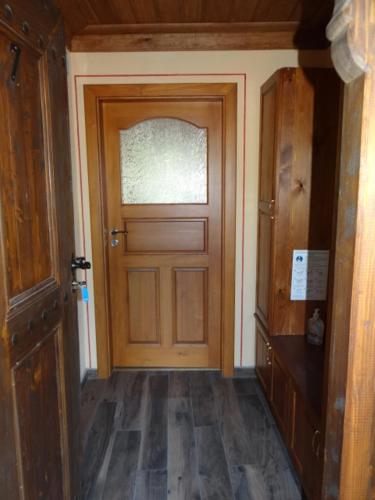 a hallway with a wooden door in a house at Недкова къща in Koprivshtitsa