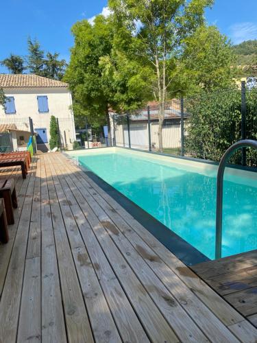 a wooden deck next to a swimming pool at Camping Frédéric Mistral in Castellane