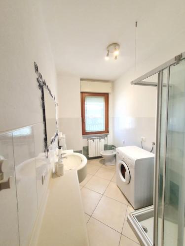 een badkamer met een wastafel en een wasmachine bij CasaFabio 7min to Garda Lake in Castiglione delle Stiviere
