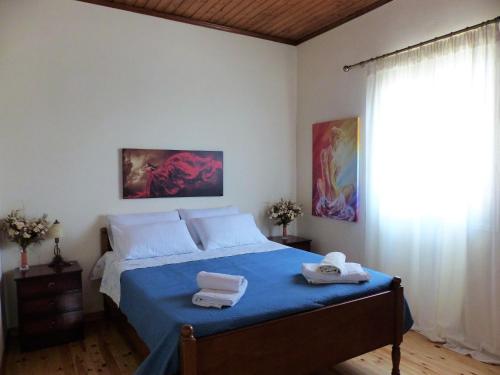 a bedroom with a bed with two towels on it at The Writers House in Ano Pavliana in Áno Pavliána