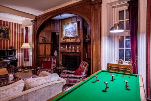 a living room with a pool table at Dalmunzie Castle Hotel in Glenshee