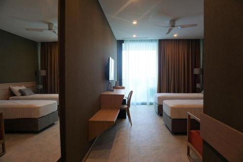 a hotel room with two beds and a desk at Mandrati Loft in Sarpi