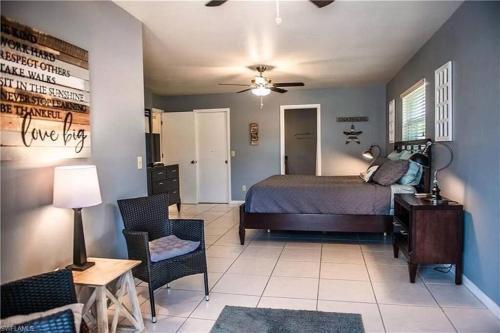 a bedroom with a bed and a table and chairs at Cape Coral Water Front Paradise in Cape Coral
