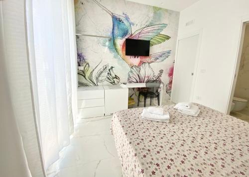 a bedroom with a peacock mural on the wall at IL VIAGGIATORE RELAIS SUL MARE in Gaeta