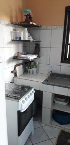 a toy kitchen with a stove and a sink at Centro Ilha comprida in Ilha Comprida