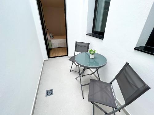 a patio with a table and two chairs at La Cala de Alcalá Luxury in Alcalá