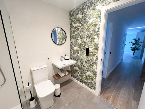 a bathroom with a toilet and a sink at La Cala de Alcalá Luxury in Alcalá
