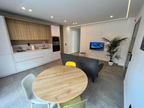 a kitchen with a wooden table and chairs in a room at La Cala de Alcalá Luxury in Alcalá