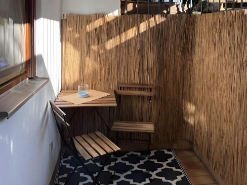 a small table and a chair in a small room at Ferienwohnung Coco in Schallstadt