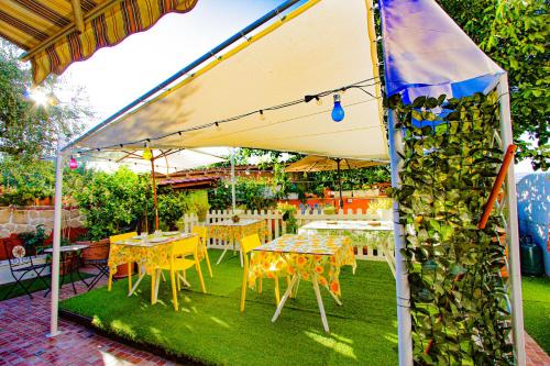 a group of tables and chairs under a tent at Eden Lilli B&B in La Pieve
