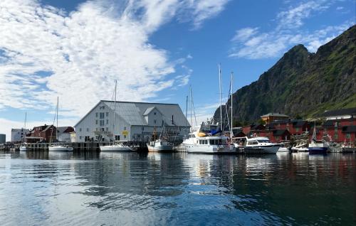a group of boats are docked in a harbor at Skjæret rorbu in Stamsund