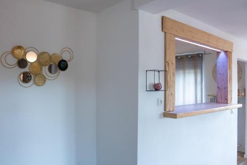 a mirror hanging on a wall in a room at Ferienwohnungen Hopfen und Malz in Fichtelberg
