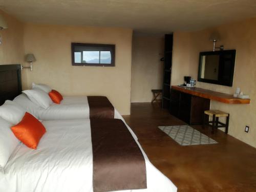 a hotel room with two beds and a sink at HOTEL ALTAVISTA in Zacatlán