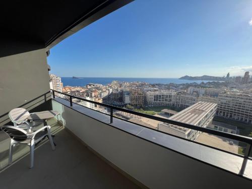 a balcony with a chair and a view of a city at Hotel Primavera Park in Benidorm