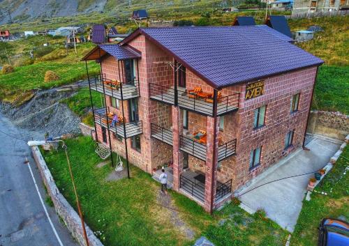 an overhead view of a house with a solar roof at Hotel Axien Kazbegi in Kazbegi