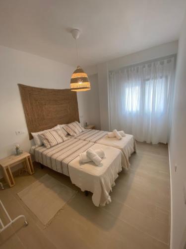 a bedroom with a large bed with two towels on it at Arenal Sweet Boutique in Platja de l'Arenal