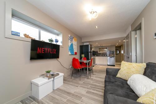 a living room with a couch and a table at Stylish Chic Home - King Bed - Free Parking & Netflix - Fast Wi-Fi - Long Stays Welcome in Edmonton