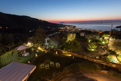 an aerial view of a house at night with lights at Villa Pane Resort in Sorrento