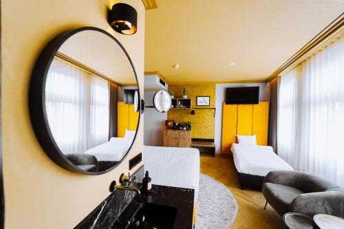 a room with a mirror and a bed and a couch at The Highlander Amsterdam in Amsterdam