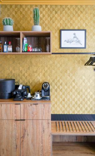 a kitchen with a counter and a table and a shelf at The Highlander Amsterdam in Amsterdam