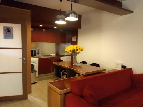 uma sala de estar com um sofá vermelho e uma cozinha em Milano 3 Apartment Pal Cigni em Basiglio