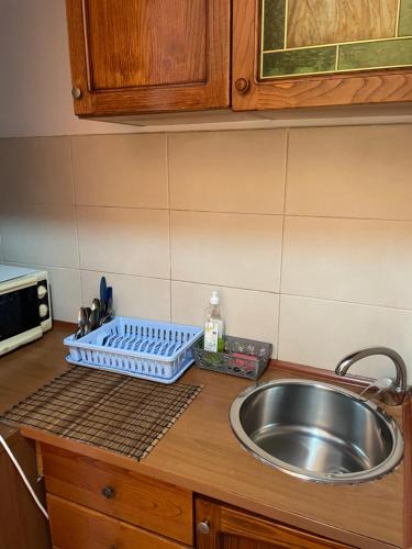 a kitchen counter with a sink next to a sink at Budget Inn Amzei in Bucharest
