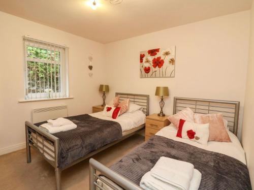 a bedroom with two beds and a window at SCOTTISH HIGHLANDS Superb 2 bedroom apartment. in Invergarry